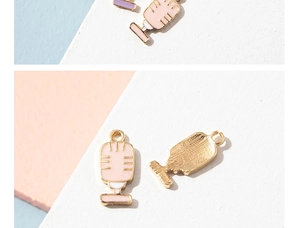 Detailed close-up of colorful enamel microphone charms with golden alloy edges and textures
