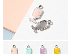 Detailed view of colorful enamel microphone charms in multiple pastel shades for DIY crafts