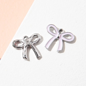 DIY bow-shaped alloy pendants in silver and pink enamel finish for jewelry making