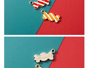 Macro detail of red and white striped candy cane enamel charms with gold-plated edges