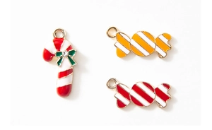 Detailed view of enamel Christmas candy cane pendants with rhinestones for DIY jewelry making