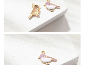 Detail of bird charms with gold plating and lavender enamel for DIY jewelry making