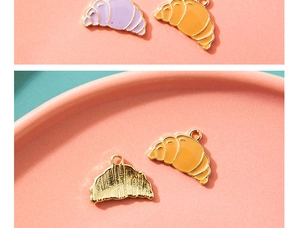 Macro view of colorful croissant charms with golden metallic texture for DIY jewelry making
