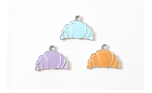 Detail of colorful croissant enamel pendants in blue purple and orange for DIY jewelry