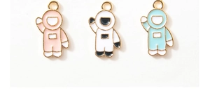 Detailed view of colorful enamel astronaut charms with golden alloy edges for DIY jewelry