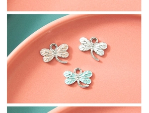Detail view of colorful dragonfly alloy pendants for DIY jewelry making and charms