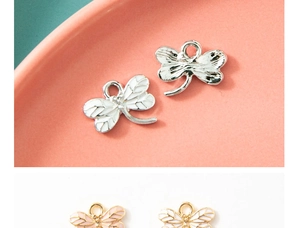 Macro view of white enamel dragonfly pendants with silver plating for DIY jewelry making