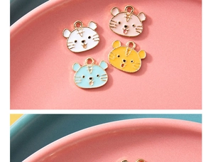 Macro view of cute cartoon tiger alloy charms in four colors for DIY jewelry crafts