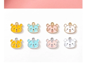 Detail of colorful tiger head alloy pendants with gold and silver enamel borders