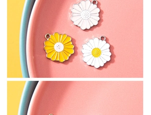 Detail of colorful daisy flower pendants for DIY jewelry with glossy enamel finish