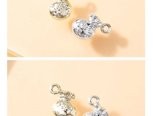Detailed close-up of lucky money bag charm with delicate floral relief for DIY jewelry