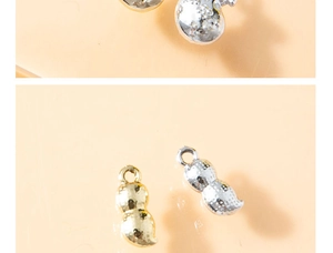 Close-up of gold and silver peanut-shaped alloy pendants with realistic textured finish