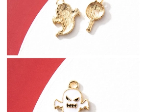 Macro shot showing front and back of Halloween ghost and candy oil-drop charms