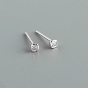 Macro view of minimalist S925 sterling silver stud earrings with square-cut zircon