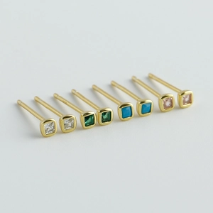 Macro detail of S925 sterling silver stamp on minimalist square zircon stud earrings set