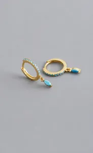 Detail of S925 sterling silver hoop earrings with gold plating and blue marquise stones