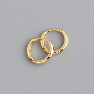 Close-up of S925 hallmark on polished gold-plated sterling silver hoop earrings