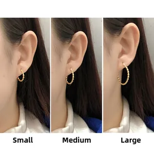 Gold beaded hoop earrings in three sizes shown on model for scale comparison