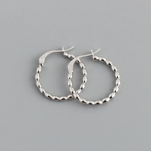 Macro view of S925 sterling silver hoop earrings with textured beaded bamboo pattern