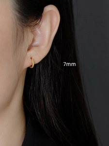 Detail of 7mm 18K gold plated S925 sterling silver hoop earring with dotted texture on ear