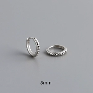 Detail view of 8mm S925 sterling silver hoop earrings featuring beaded texture and hallmarking