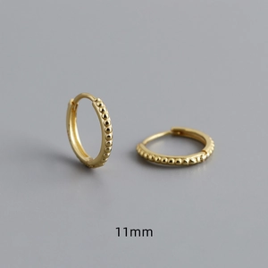 Macro detail of 11mm gold beaded hoop earrings in S925 sterling silver with hinge closure