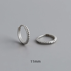 Detailed macro view of 11mm S925 sterling silver hoop earrings with textured dotted design