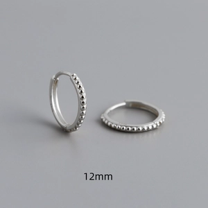 Macro shot of 12mm S925 sterling silver hoop earrings with beaded milgrain texture