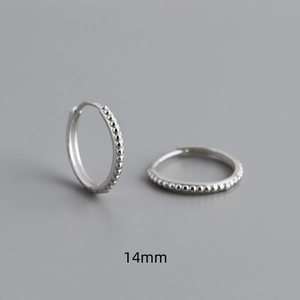 Macro detail of 14mm S925 sterling silver hoop earrings with a beaded dot texture design