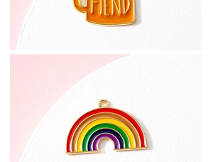 Macro-detail van de emaille regenboog bedel en oranje mok hanger voor DIY-sieraden
