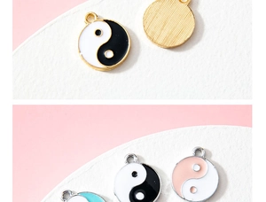 Detailed close-up of Tai Chi Yin Yang enamel charms in gold and silver plating