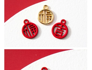 Macro detail of red and gold Chinese Fu and Ji alloy pendants for jewelry making