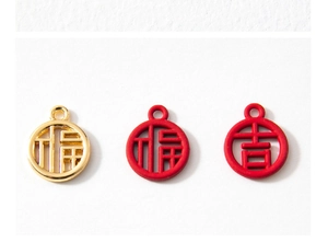Macro detail of alloy pendants featuring gold and red Fu and Ji lucky characters
