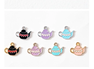 Detailed view of colorful teapot enamel charms in gold and silver plating for DIY jewelry