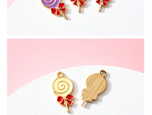 Detailed view of enamel lollipop charms with red bows and gold-plated textured backing