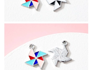 Detail view of colorful enamel windmill charms with metal textured back for DIY jewelry