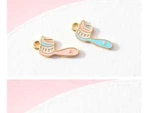 Macro detail of cute toothbrush charms in pink and blue enamel for DIY jewelry making