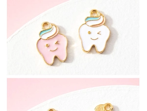 Macro shot of cute cartoon tooth charms with smiley faces and pink enamel finish