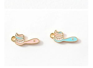 Detail of pink and blue DIY alloy charms in cute toothbrush and toothpaste shapes