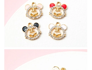 Detailed view of four enamel tiger charms with rhinestones in pink, red, black, and white
