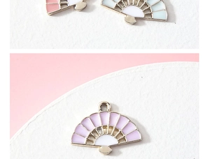 Close-up of enamel fan charms in pastel colors with gold alloy edges for DIY jewelry