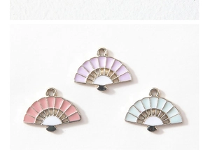 Detail of DIY fan-shaped enamel charms in pink, purple, and teal with metal loops