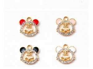 Detail of four rhinestone tiger head DIY pendants with red, pink, black and white enamel