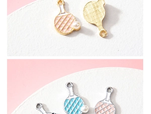Macro shot of ping pong paddle pendants with colorful enamel coating and faux pearl accents