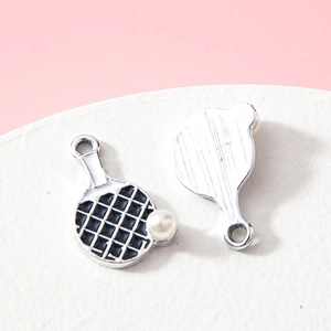 Alloy ping pong paddle charm with pearl detail and black white grid on pink background