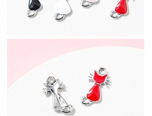 Macro detail of cat alloy charms showing colorful enamel finish and metal back for DIY jewelry