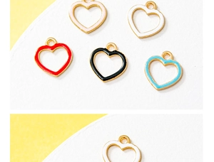 Detailed view of heart-shaped alloy enamel charms in five colors with golden metallic frames