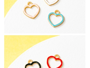 Close-up of DIY heart-shaped alloy enamel pendants in various colors for jewelry making