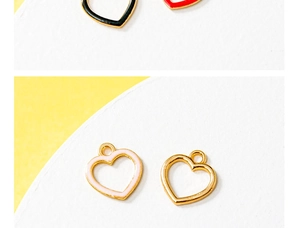 Detailed view of colorful heart enamel charms with gold metal edges for DIY jewelry
