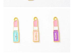 Detail of three lipstick charms with WOW text and colorful enamel in gold plating